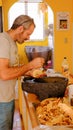 Tourist enjoys spicy Chicharron at mexican market in Aculco