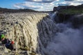 Tourist on the edg of Detifoss waterfall. One of the best attraction in Iceland. Dettifoss is the most powerful waterfall on