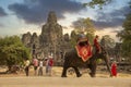 A tourist on an elephant ride, tours the ancient Bayon Temple in Angkor Wat Cambodia