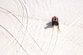 Tourist enjoy riding the quad bike or powerful fast off-road four-wheel drive ATVs at white sand dunes