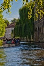 Tourist  enjoying  a boat trip along the canales on a sunny summers  day in Bruges Belgum Royalty Free Stock Photo