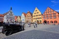 Tourist enjoying Markplatz with traditional houses and vintage car on the foreground in Rothenburg ob der Tauber