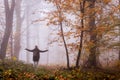 Tourist enjoying positive energy in autumn forest Royalty Free Stock Photo