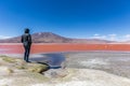 Tourist enjoying the surreal view of Laguna Colorado in Bolivia