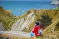 Tourist enjoying view of Man O`War Cove on the Dorset coast in southern England, between the headlands of Durdle Door to the west Royalty Free Stock Photo