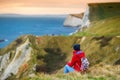 Tourist enjoying view of Man O`War Cove on the Dorset coast in southern England, between the headlands of Durdle Door to the west Royalty Free Stock Photo