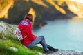 Tourist enjoying view of rugged Cornish coastline near Port Isaac historic fishing village on sunny morning, Cornwall, England Royalty Free Stock Photo