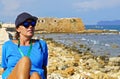 A tourist enjoys a beautiful sunny October day admiring the old city from the port walls, Xania, Crete Royalty Free Stock Photo