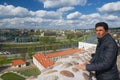 Tourist enjoys the view to the city from Gediminas hill in Vilnius, Lithuania.