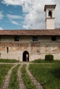 Tourist entering in the old church in the small village of Zona near at Pyramids of Zone - Lombardy Italy