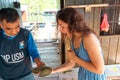 Tourist excursion to the fish farm. Girl tourist is surprised for the first time holding a stingray crab in her hand
