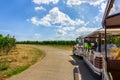 Tourist excursion train in champagne vineyards at montagne de reims on countryside village background