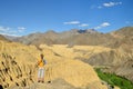 Tourist during expedition in the mountains Ladakh is admiring the beautiful Karakorum panorama in the vicinity of the Lamayuru tow