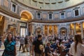 Tourist explore the Pantheon, located at Piazza della Rotonda, on a cloudless summer day