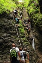 Tourists climbing iron ladders in Slovak Paradise Royalty Free Stock Photo