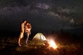 Tourist family with daughter having a rest in mountains at night under starry sky with Milky way Royalty Free Stock Photo