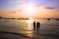 Tourist family are enjoy swimming on sea in evening time before sun set.silhouette group of people in relax time with seascape,