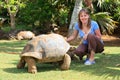 Tourist feeding giant turtle