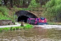 A tourist ferry boat enters a tunnel from Falkirk Wheel boat lift to Union Canal locks