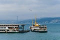 Tourist ferry ride along the Golden horn Bay in Istanbul. Tourist ferries in the Golden horn Bay on the background of the bridge