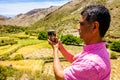 Tourist filming a Valley in the Atlas mountains