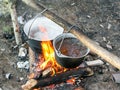 Tourist fire with cooking pots with boiling water.