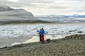 Tourist at FjallsÃÂ¡rlÃÂ³n glacier lagoon in south Iceland