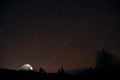 Tourist with flashlight near his camp tent under a sky full of stars, night mountain loneliness Royalty Free Stock Photo