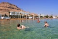 Tourist floating over the Dead sea in Ein Bokek an hotel and resort district in Israel