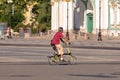 A tourist on a folding bike rides through the town square Royalty Free Stock Photo