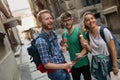 Tourist friends discovering city on foot Royalty Free Stock Photo