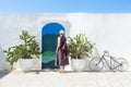 Tourist in front of Blue door with cactus and the traditional white walls in the town of Ostuni (Puglia - Italy Royalty Free Stock Photo