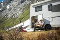 Tourist in Front of His Motor Home Taking Short Break to Eat Some Food