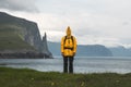 Tourist in funny yellow jacket at Trollkonufingur viewpoint