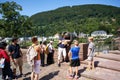 Tourists having fun at the famous Heidelberg Monkey on the banks of the Neckar River in Germany.