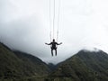 Tourist on giant swing adventure ride at Manto de la novia Bridal Veil waterfall Pastaza river Banos Tungurahua Ecuador Royalty Free Stock Photo