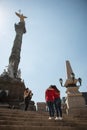 Tourist girfriends taking picture together, Angel de la Indepedencia