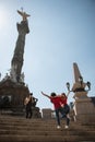 Tourist girfriends taking picture together, Angel de la Indepedencia