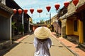 Woman with vietnamese hat in the historic street of Hoi An Vietnan