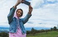 Tourist girl on background blue sky clouds taking photo selfie on mobile smart phone, person looking on camera gadget technology