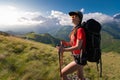 A tourist girl with a backpack admires the sunset from the mount Royalty Free Stock Photo