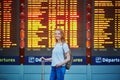 Tourist girl with backpack in international airport Royalty Free Stock Photo