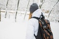 Tourist girl with backpack standing near at the entrance of a hotel, travel at New Year concept Royalty Free Stock Photo