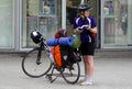 Tourist girl with bicycle looking to the map