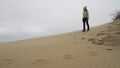 Tourist girl among Curonian Spit sand dunes Royalty Free Stock Photo