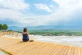 Tourist girl in dress with hat in Natural travertine pools and terraces in Pamukkale. Cotton castle in Turkey. Woman in pamukkale.