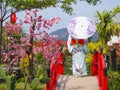 Tourist girl in kimono costume holding umbrella in Japanese garden style Royalty Free Stock Photo