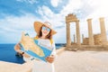 Girl looking at map at the background of ancient Greek archaeological site and Acropolis. Travel the world and greatest Royalty Free Stock Photo