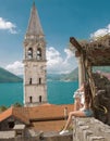 Tourist girl in Montenegro. Young traveller sightseeing bell tow