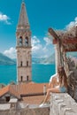 Tourist girl in Montenegro. Young traveller sightseeing bell tow